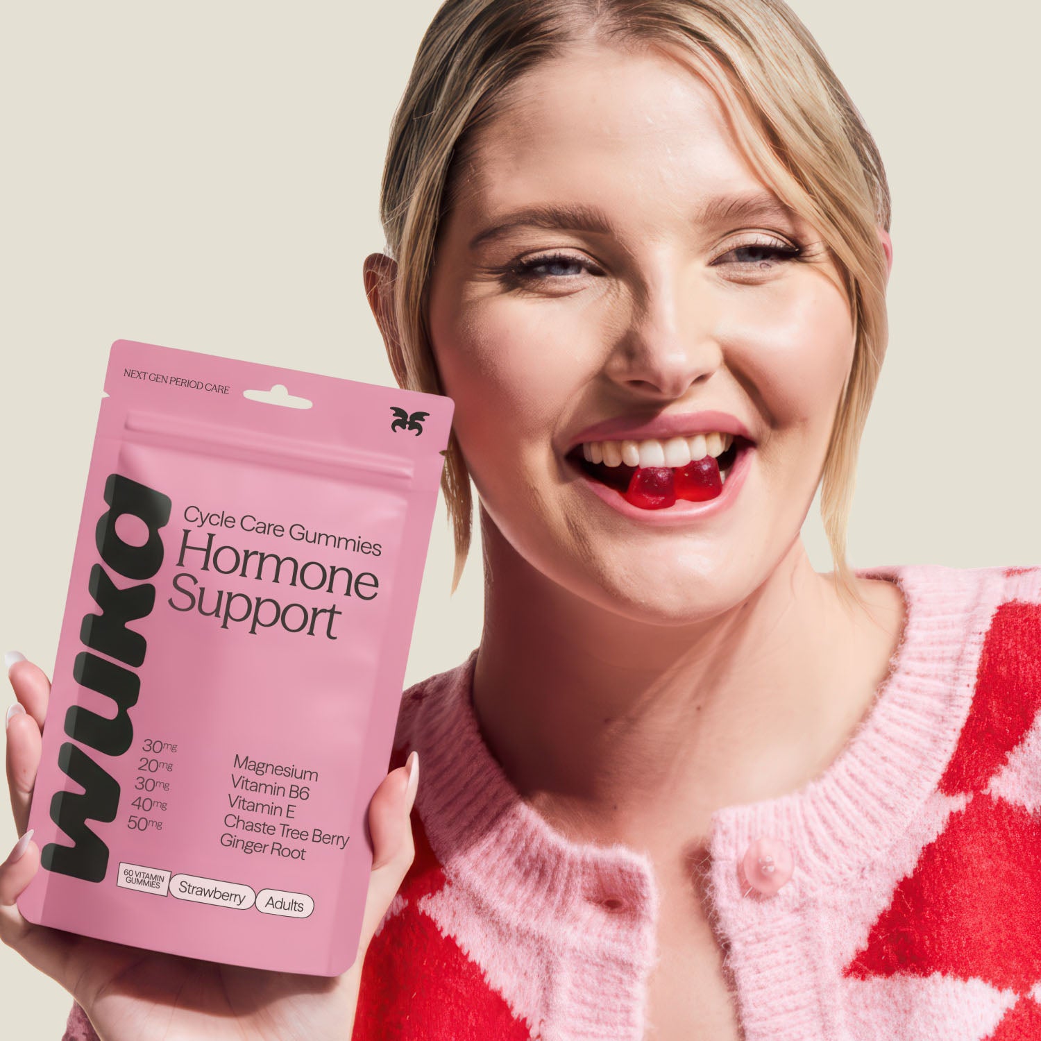 Smiling woman holding WUKA Hormone Support Gummies with strawberry flavour for hormone balance and PMS support.