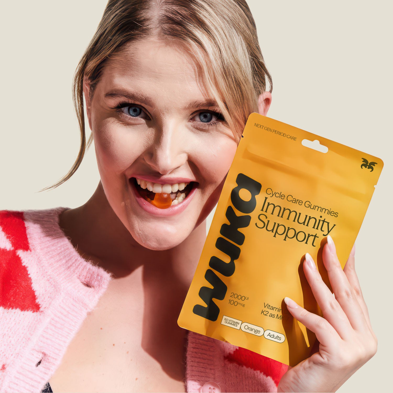 Smiling woman enjoying WUKA Immunity Support gummies for daily vitamin D3 and K2 wellness boost.