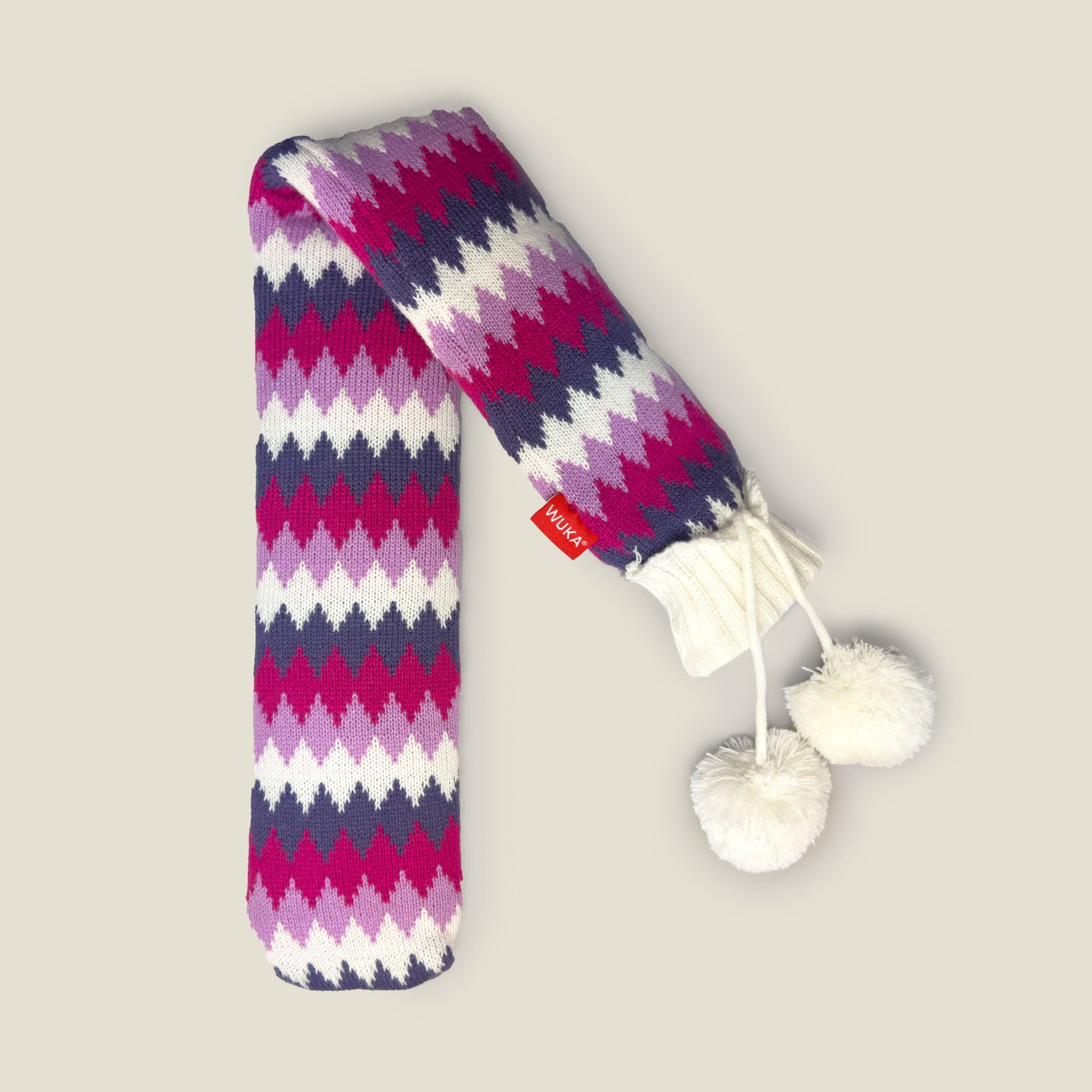 WUKA extra long hot water bottle with knitted zigzag cover in pink, purple, and white pattern, featuring pom pom drawstrings.