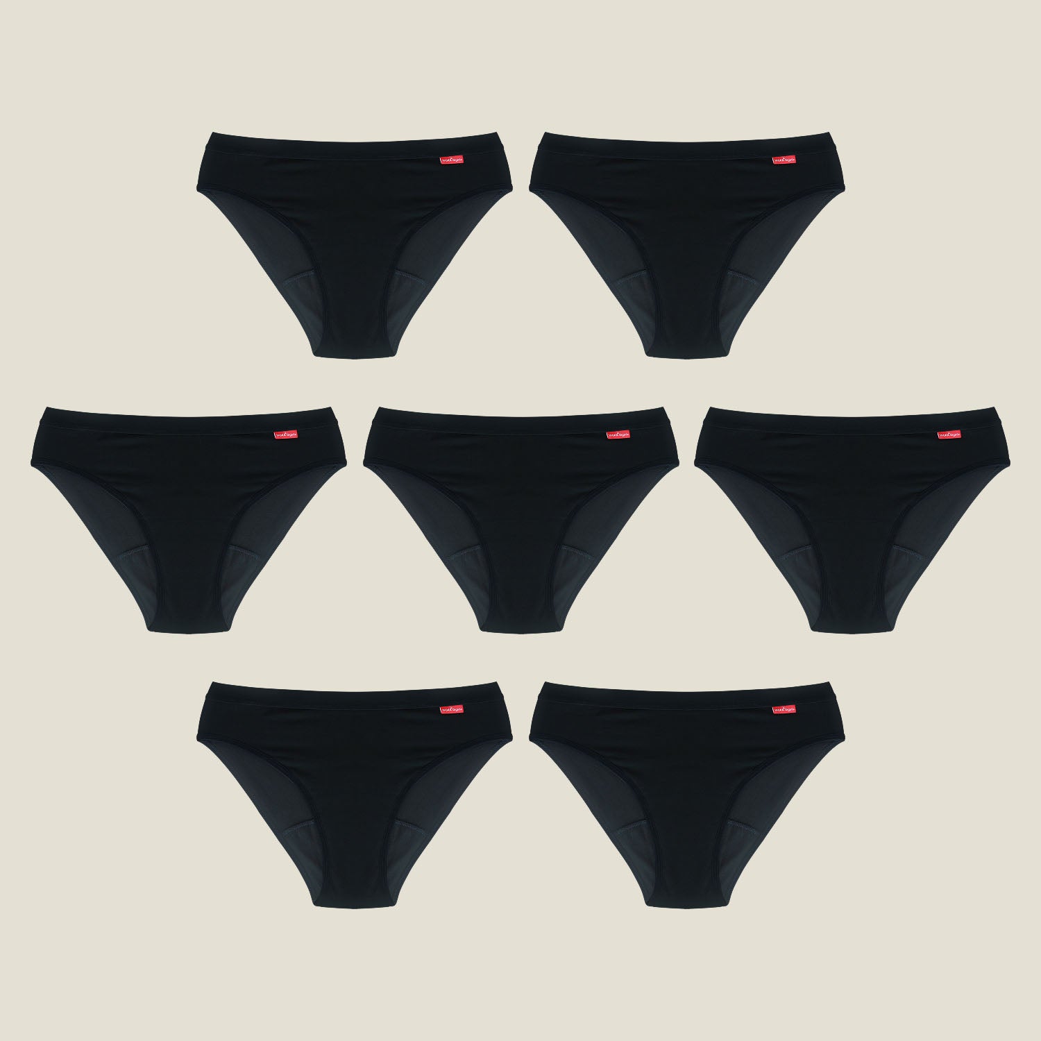 Flat lay of the WUKA Ultimate™ Bikini Medium Flow 7-Pack Period Pants, displayed in a pyramid layout, showing seven black bikini-style period underwear made from soft organic cotton.