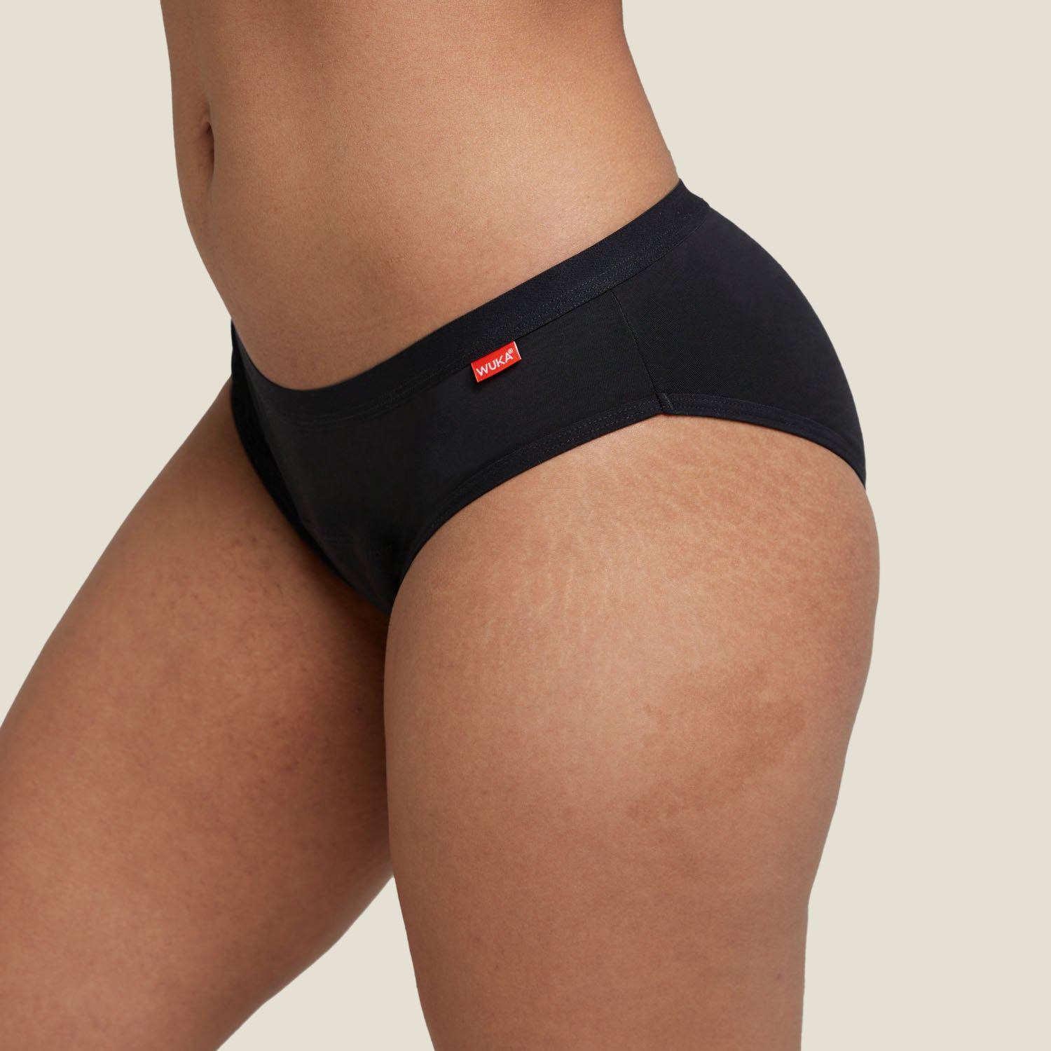 Close-up of the front of WUKA Basics™ Hipster heavy flow period underwear, highlighting the discreet WUKA logo and soft waistband.