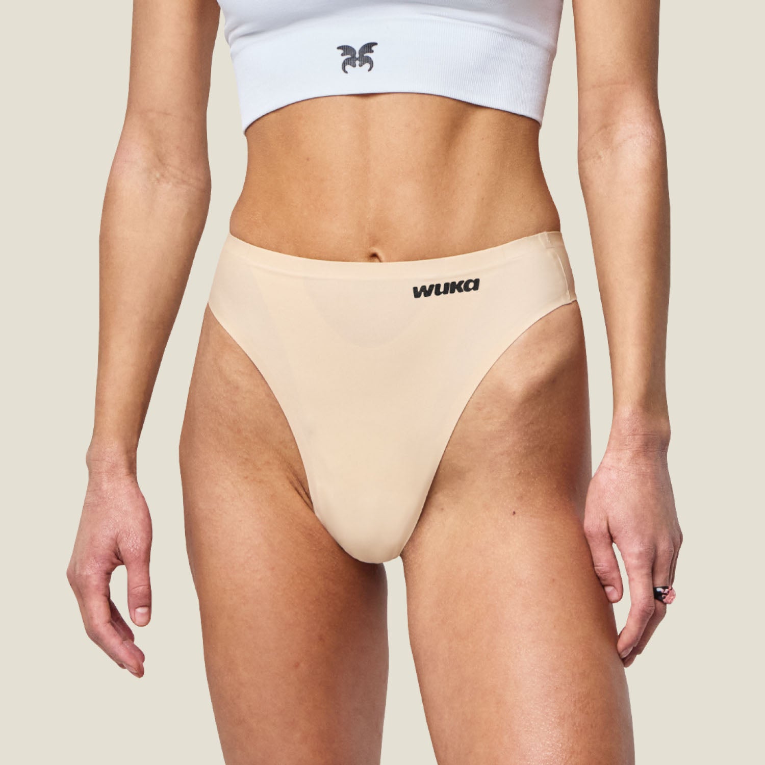 Close-up of WUKA Light Nude Stretch Thong for light flow, showing high-rise waistband and discreet leak-proof gusset.