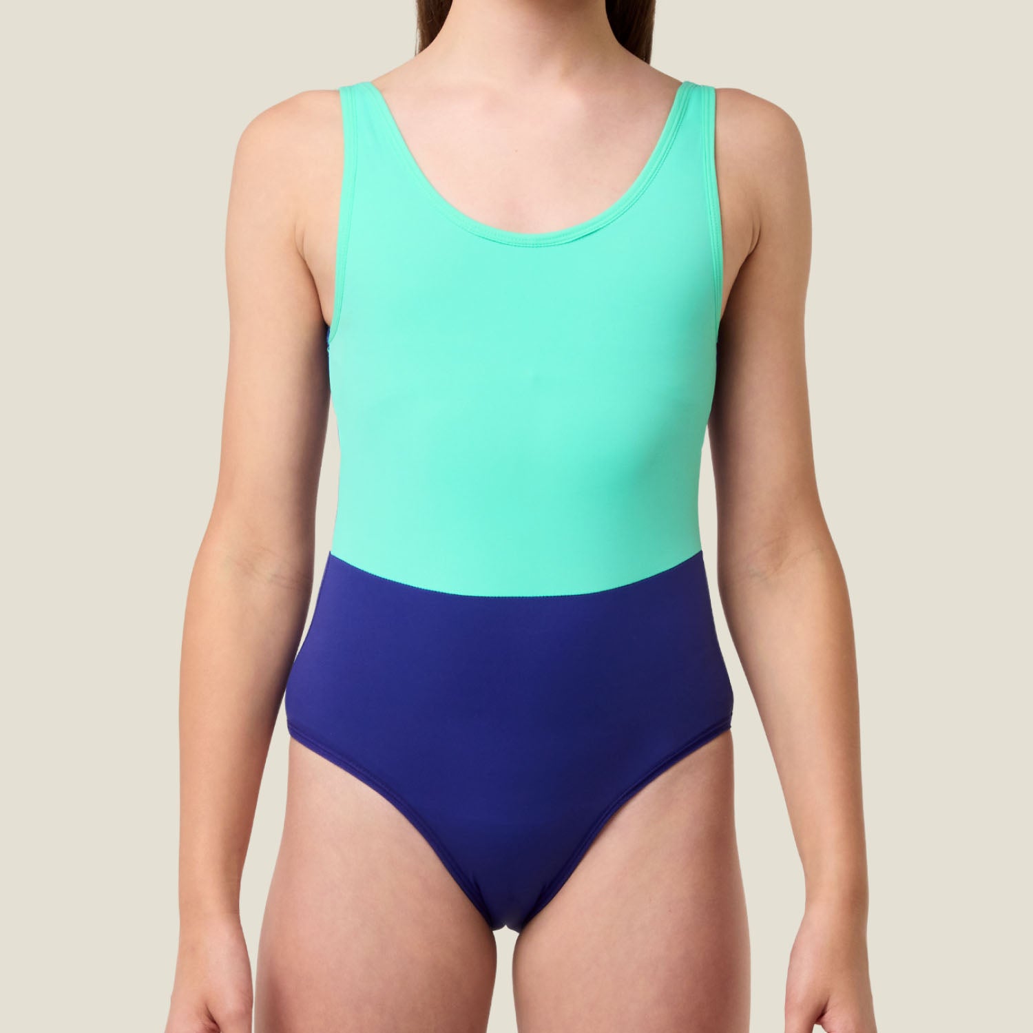Front close-up of the green and blue WUKA Teen Racerback Period Swimsuit, highlighting scoop neckline and seamless design for discreet, comfortable period swimwear.
