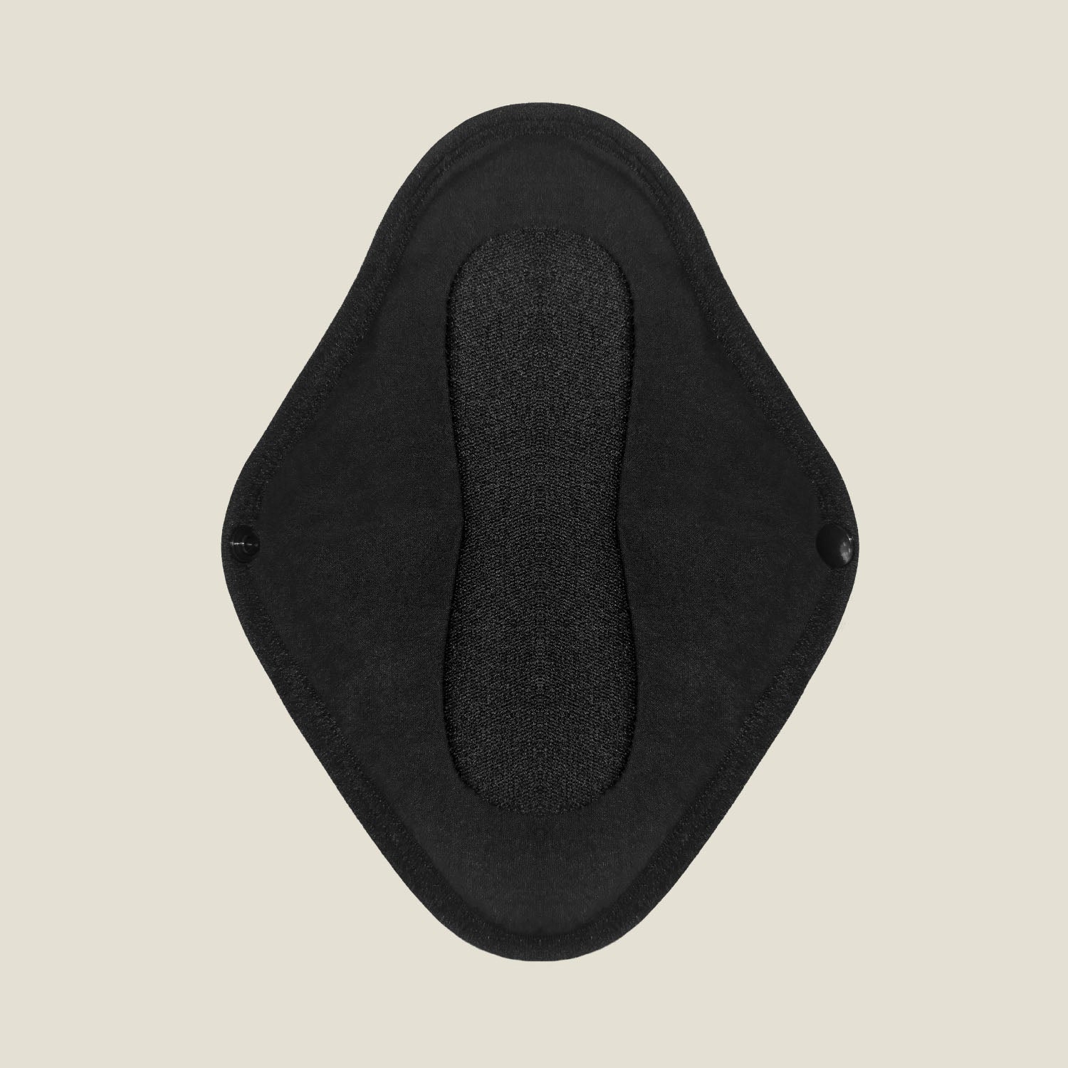 Top view of WUKA x Mooncup reusable pad open flat, revealing black absorbent inner layer and winged design with snap fastening.