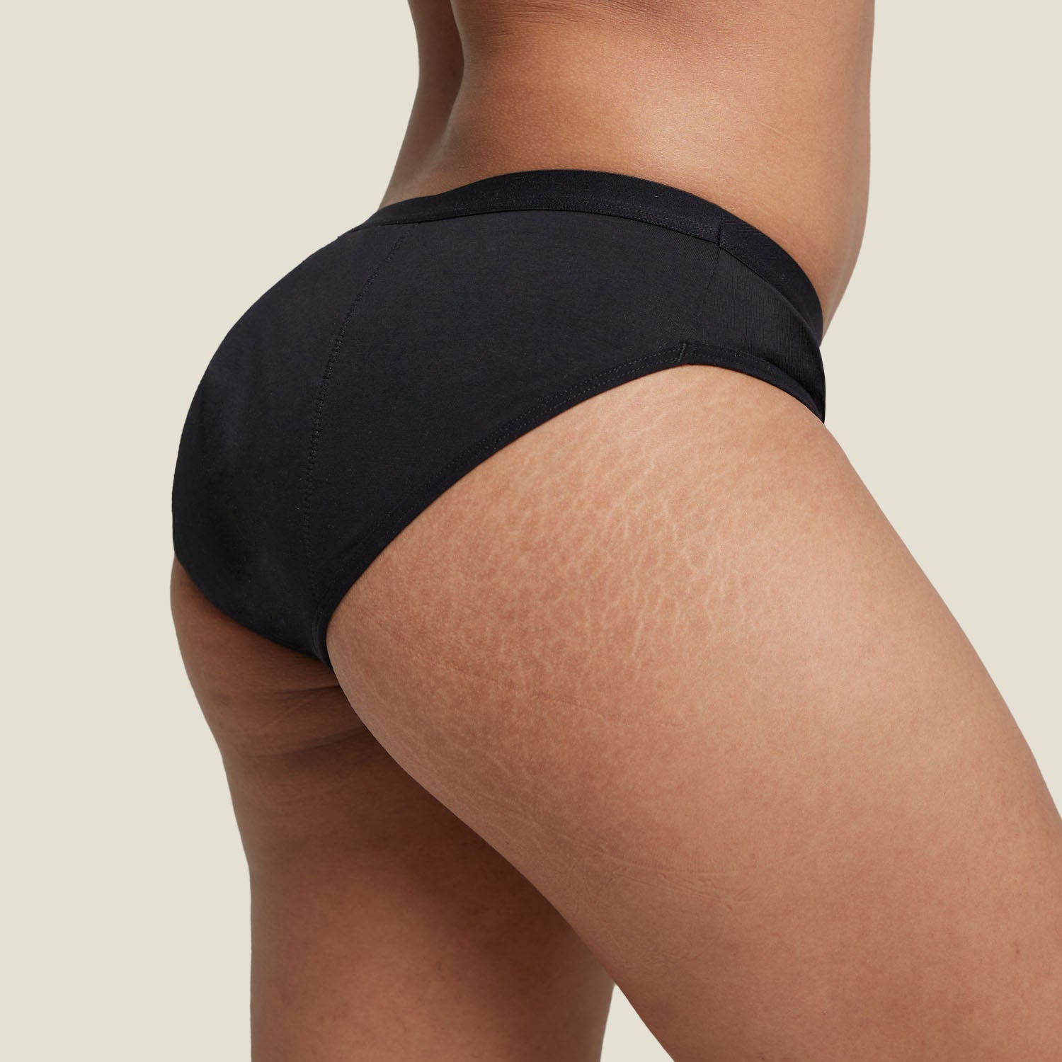 Side view of WUKA Basics™ Hipster Period Underwear for medium flow in black, showing seamless comfort design.