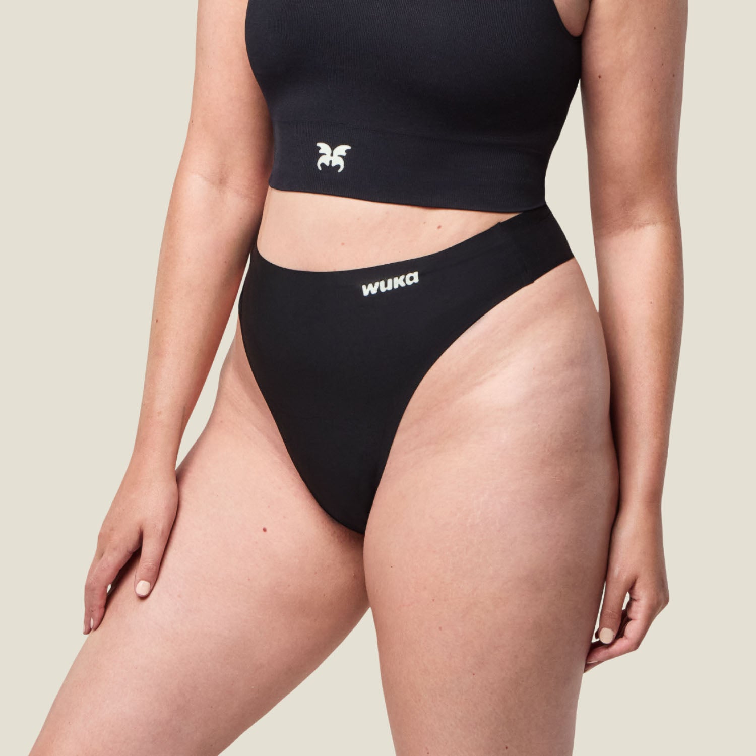 Side profile of WUKA black period thong, highlighting its smooth waistband and light flow absorbency for everyday wear.