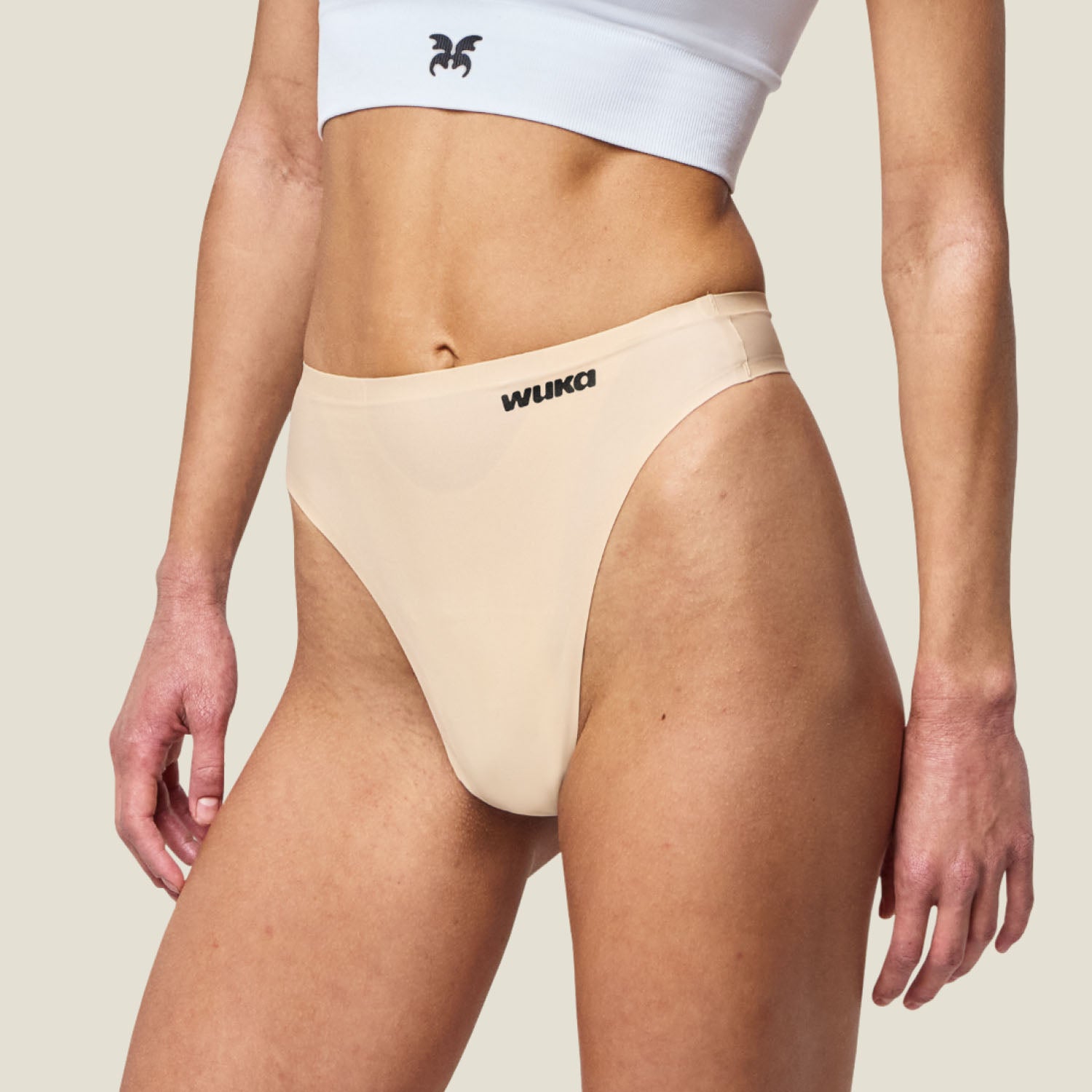 Side profile of WUKA period-proof Stretch Thong in Light Nude, offering discreet and flexible fit for light flow days.