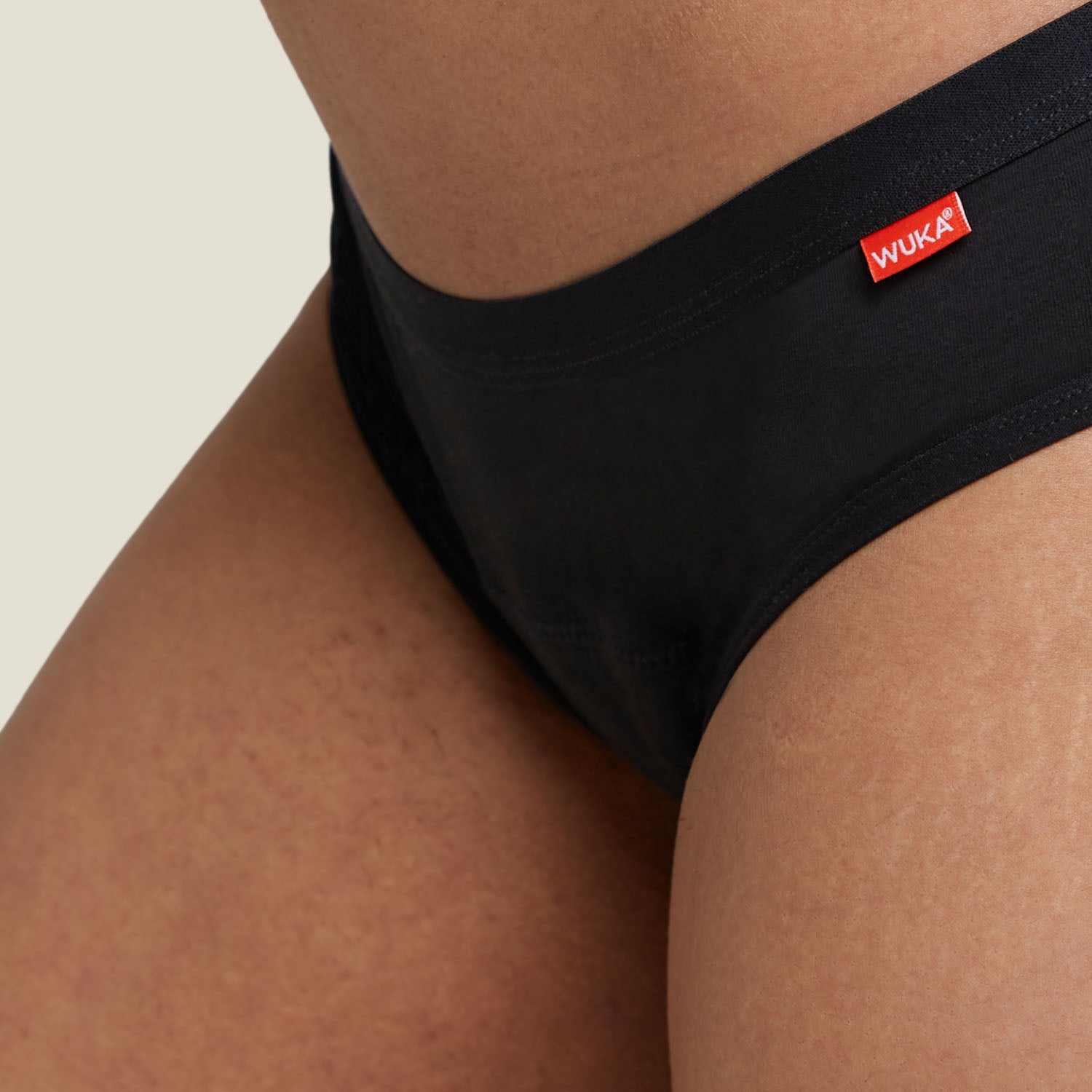 Detail shot of WUKA Basics™ Hipster heavy flow period pants, focusing on the waistband and premium organic cotton texture.