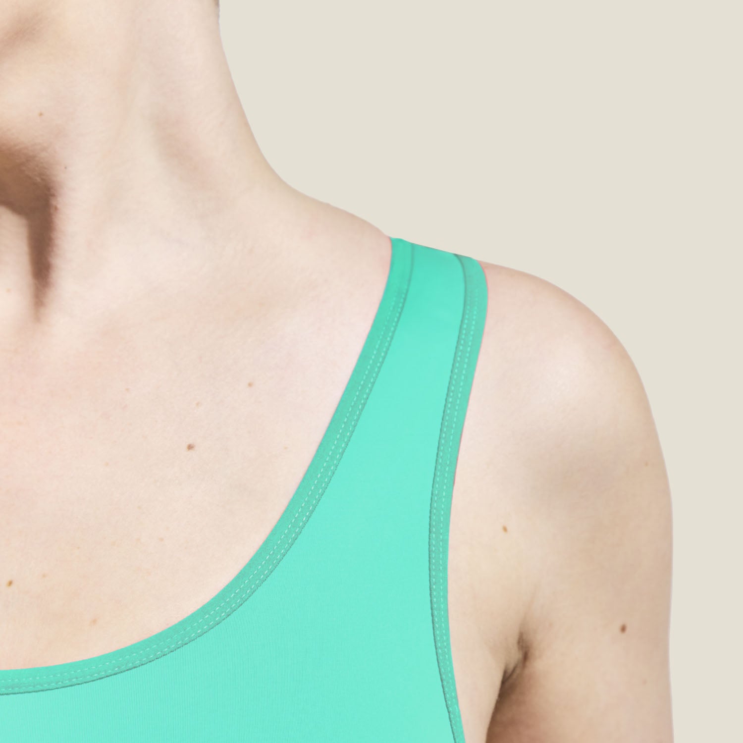 Zoomed-in view of stitching and fabric texture on the WUKA Teen Racerback Swimsuit. Chlorine-resistant and UV50+ period-proof swimwear with technical detailing.