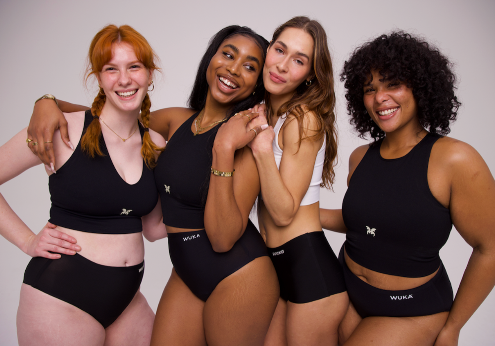 4 girls laughing together while wearing the WUKA Stretch