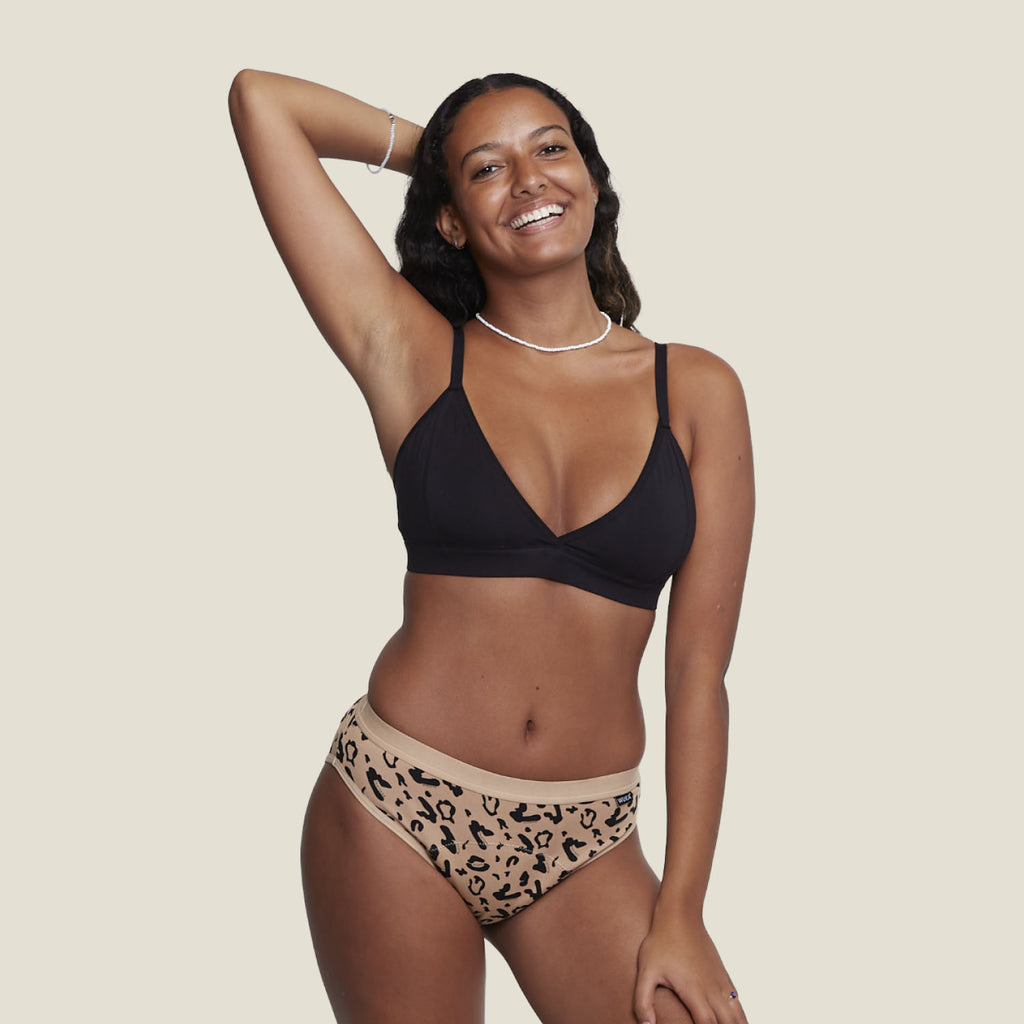 Model wearing WUKA Basics™ Leopard Print Bikini for heavy flow periods, made from sustainable cotton and designed for maximum comfort and leak protection