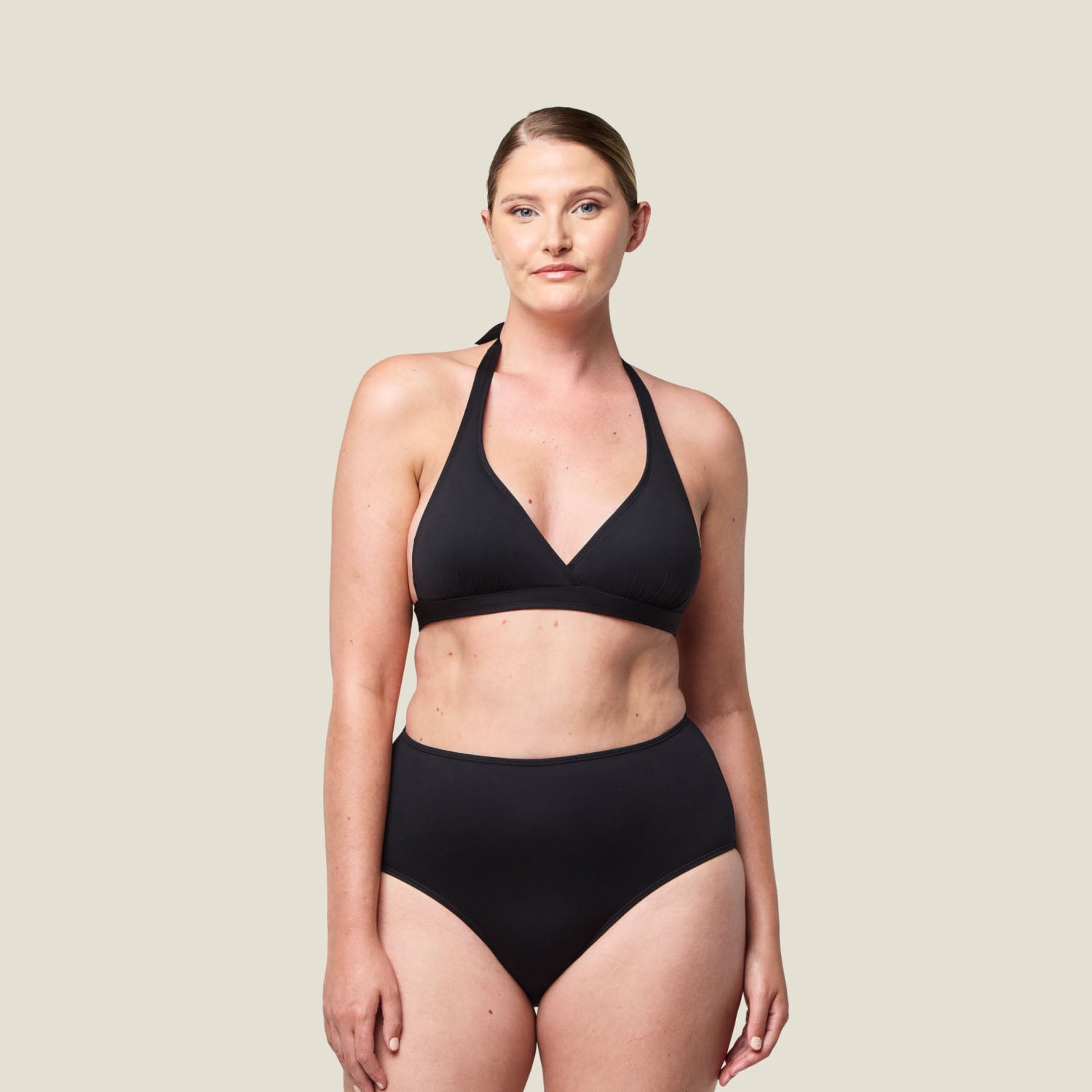 Model wearing WUKA Adult Swim High Waist period pants in black, designed for light flow protection with a flattering high-waisted fit, perfect for swimming during periods.