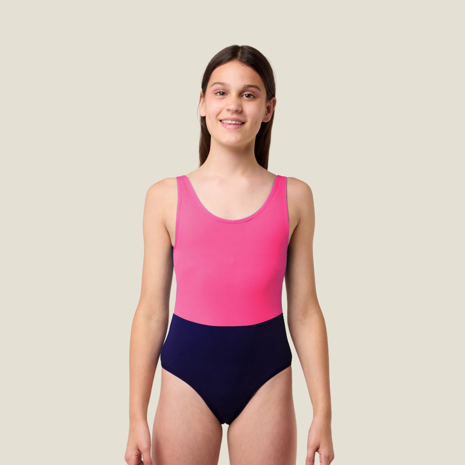 Teen wearing WUKA Teen Period Racerback Swimsuit in pink and purple, full-length front view showing scoop neckline and medium-flow design.