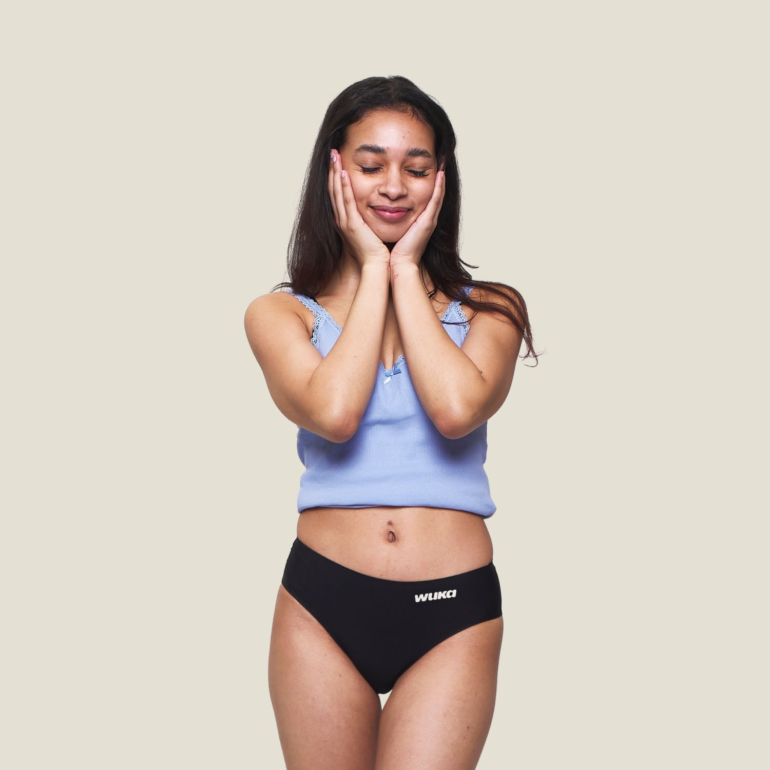 Teen model wearing WUKA Teen Stretch™ Super Heavy Period Pants in black, leak-proof protection for very heavy flow.