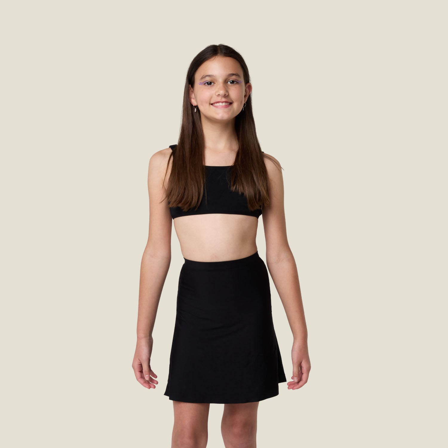 Teen wearing WUKA Stretch Seamless Skort in black for heavy period flow — leak-proof and comfy coverage.