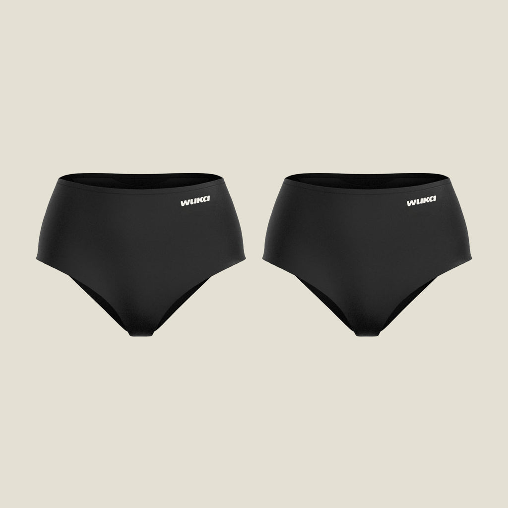 Two pairs of WUKA Stretch Seamless High Waist Period Pants for heavy flow in black, displayed flat against a neutral background, featuring a supportive high-rise fit and discreet logo branding.