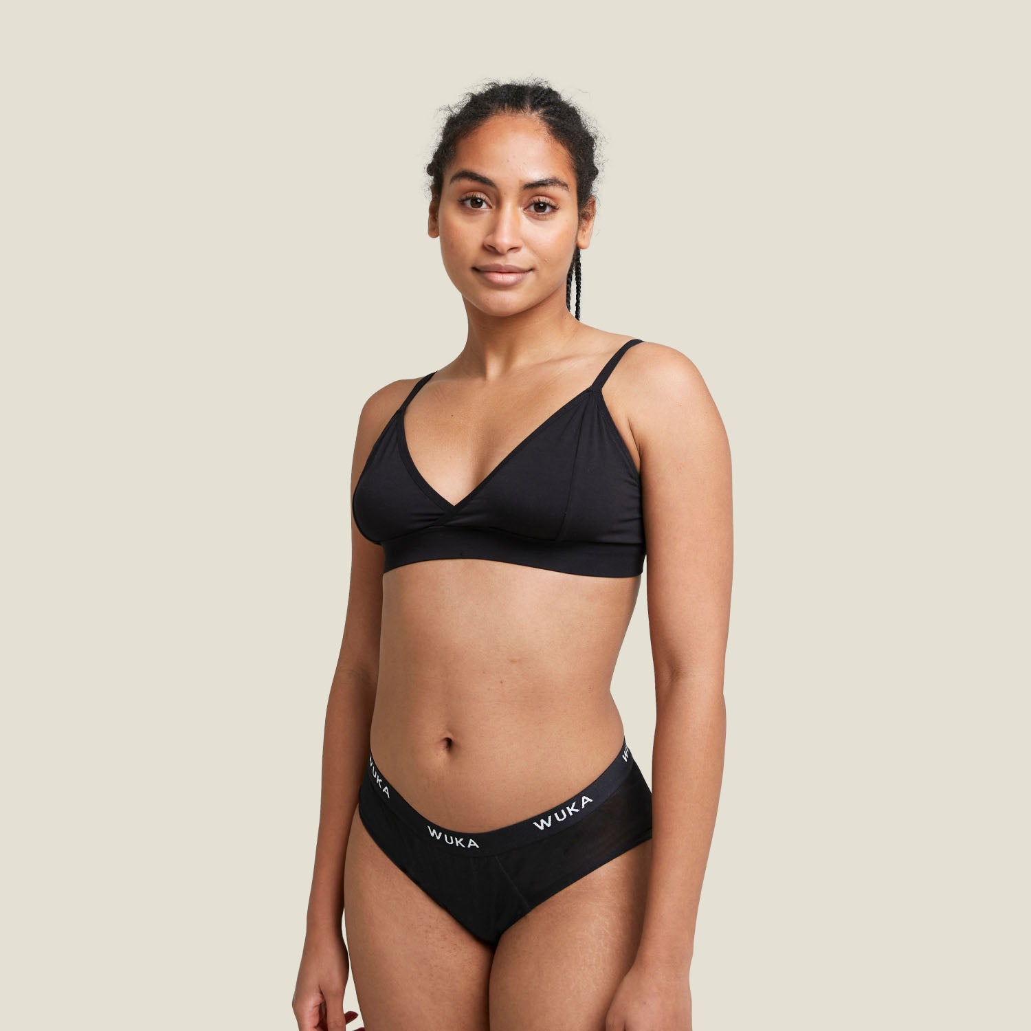 Model wearing WUKA Ultimate™ Midi Brief in black, designed for heavy overnight flow protection with a comfortable fit and soft waistband.