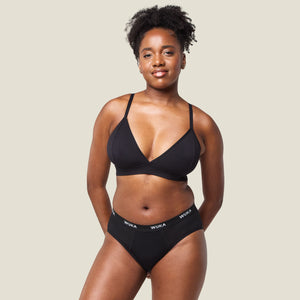 Model wearing WUKA Ultimate™ Midi Brief Super Heavy Flow period underwear in black, full body front view for comfortable and secure protection.