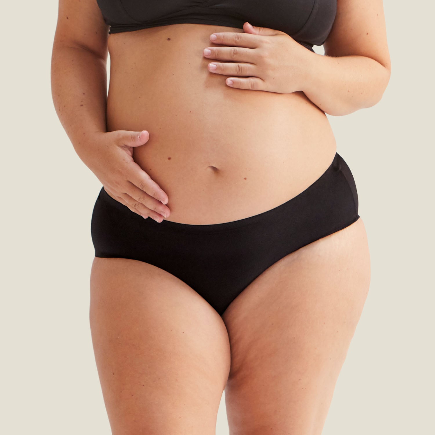 Close-up front view of black Drytech™ midi brief designed for light incontinence, shown on a pregnant model.