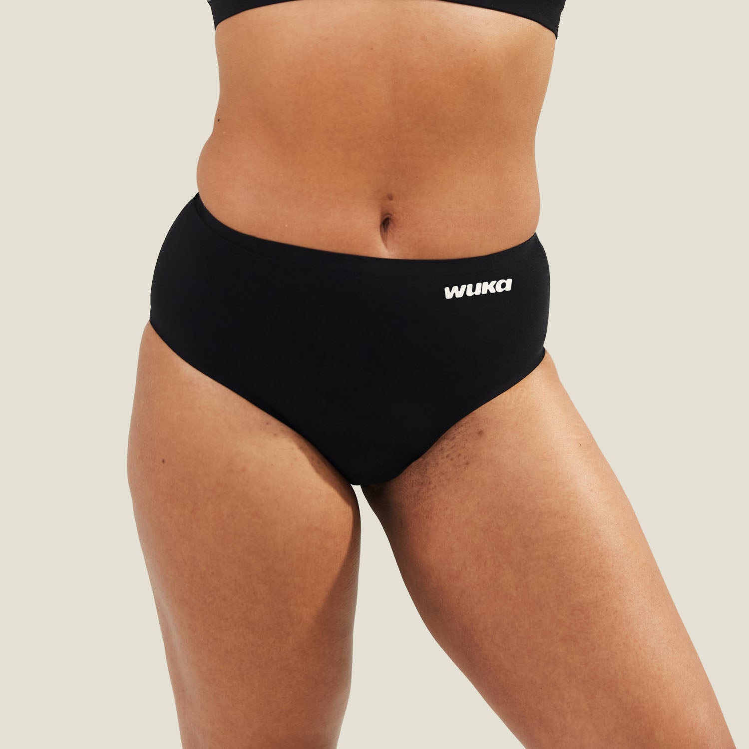 Close-up of WUKA Stretch Seamless Midi Brief in black, highlighting ultra-soft fabric and discreet leak-proof protection for medium flow.