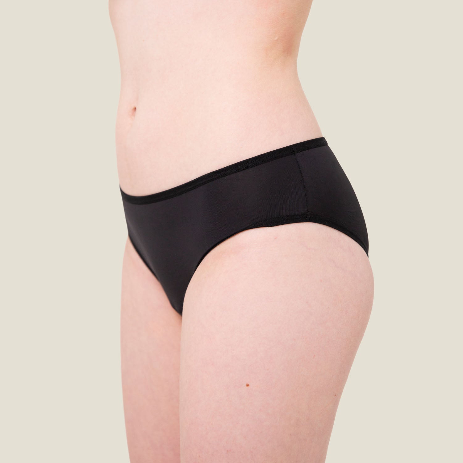 Close-up front view of WUKA Teen Swim Bikini Brief in black, showcasing sleek fit and discreet period protection ideal for swimming.