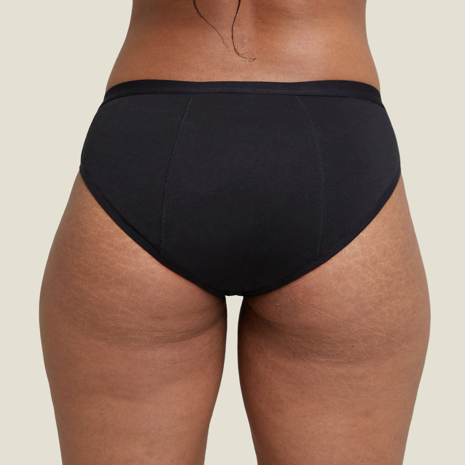 Rear view of WUKA Basics™ Hipster Period Pants in black for medium flow, highlighting full coverage and secure fit.