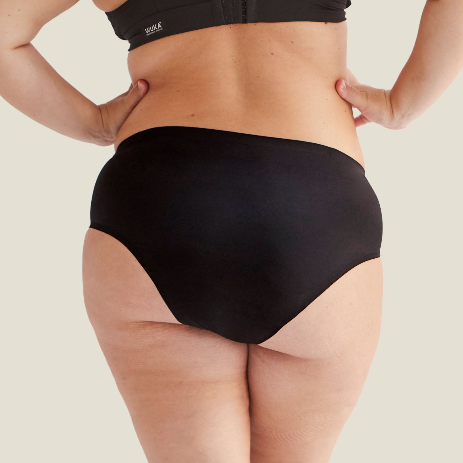 Rear view of Drytech™ midi brief in black, demonstrating full back coverage and leak-proof protection.