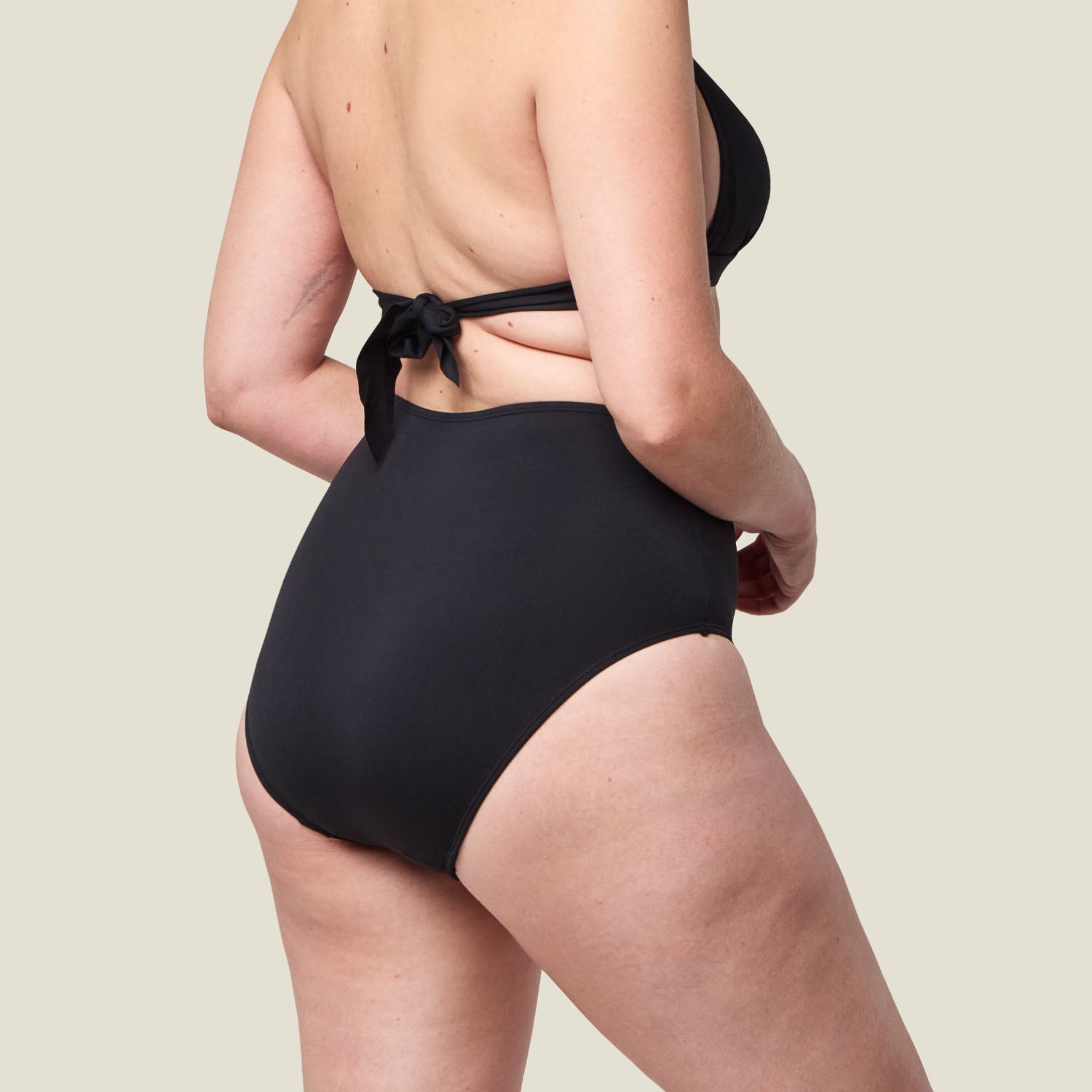 Rear view of WUKA Swim High Waist period pants in black, highlighting full coverage and leak-proof confidence for light flow days.