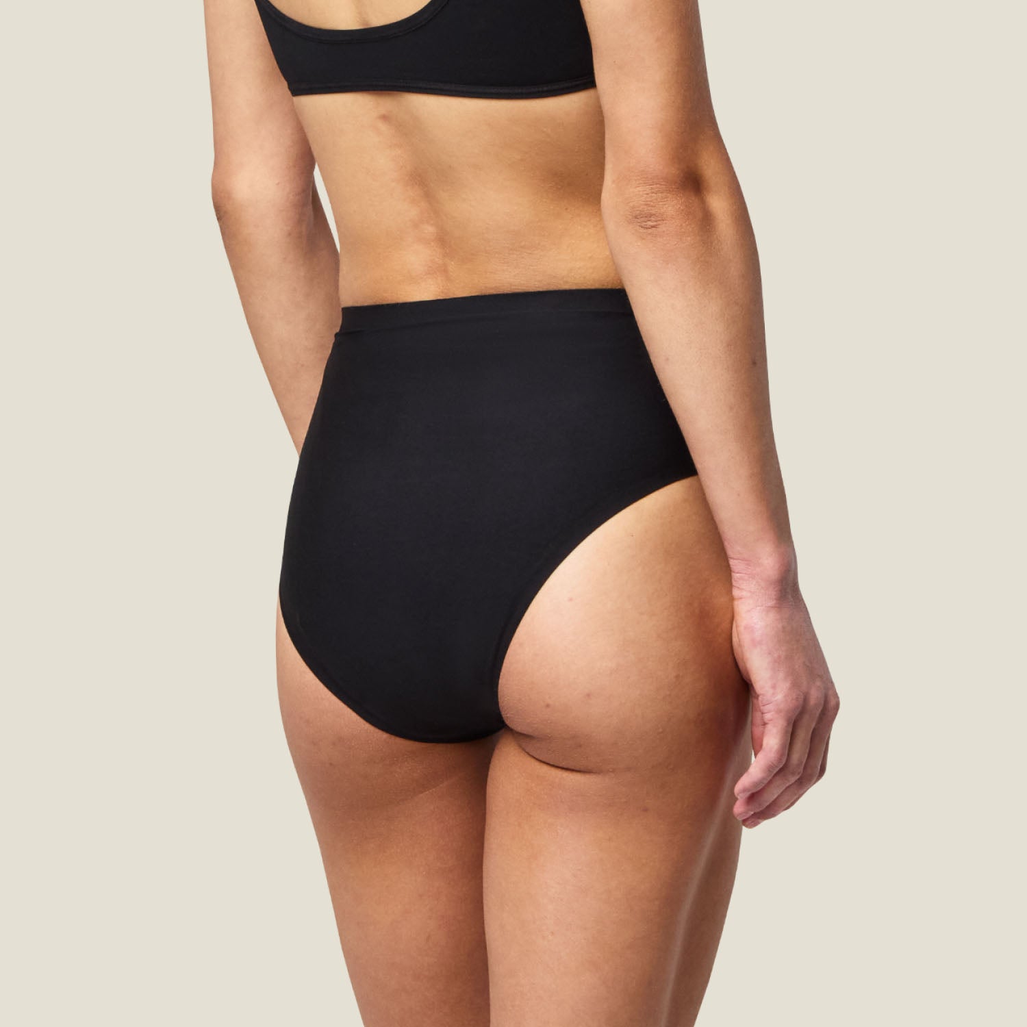 Rear view of WUKA Stretch™ Midi Brief in black, period underwear for heavy flow with seamless high-waist design.