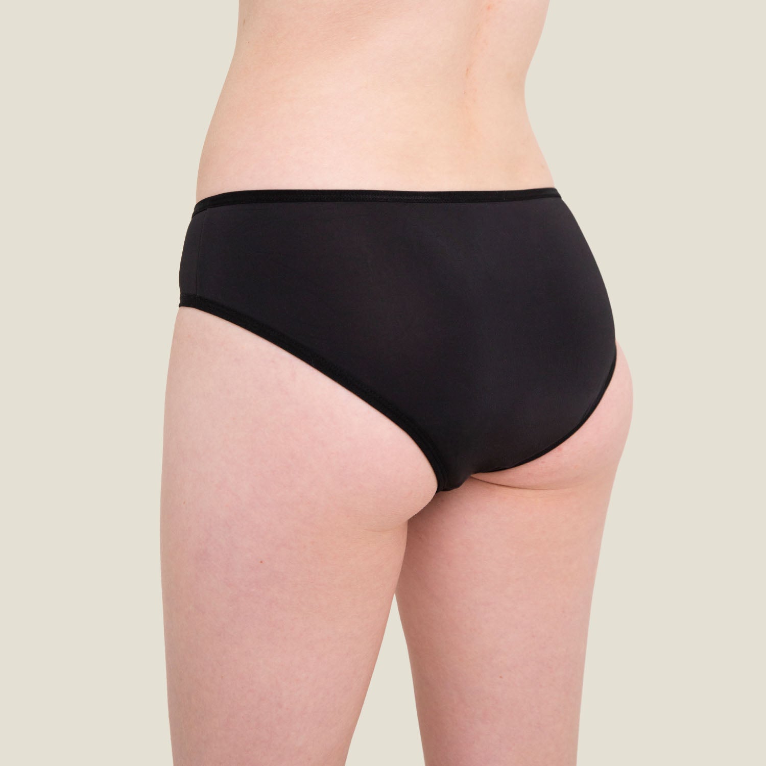 Back view of WUKA Teen Swim Bikini Brief in black, demonstrating secure coverage and leak-proof protection for light flow days.