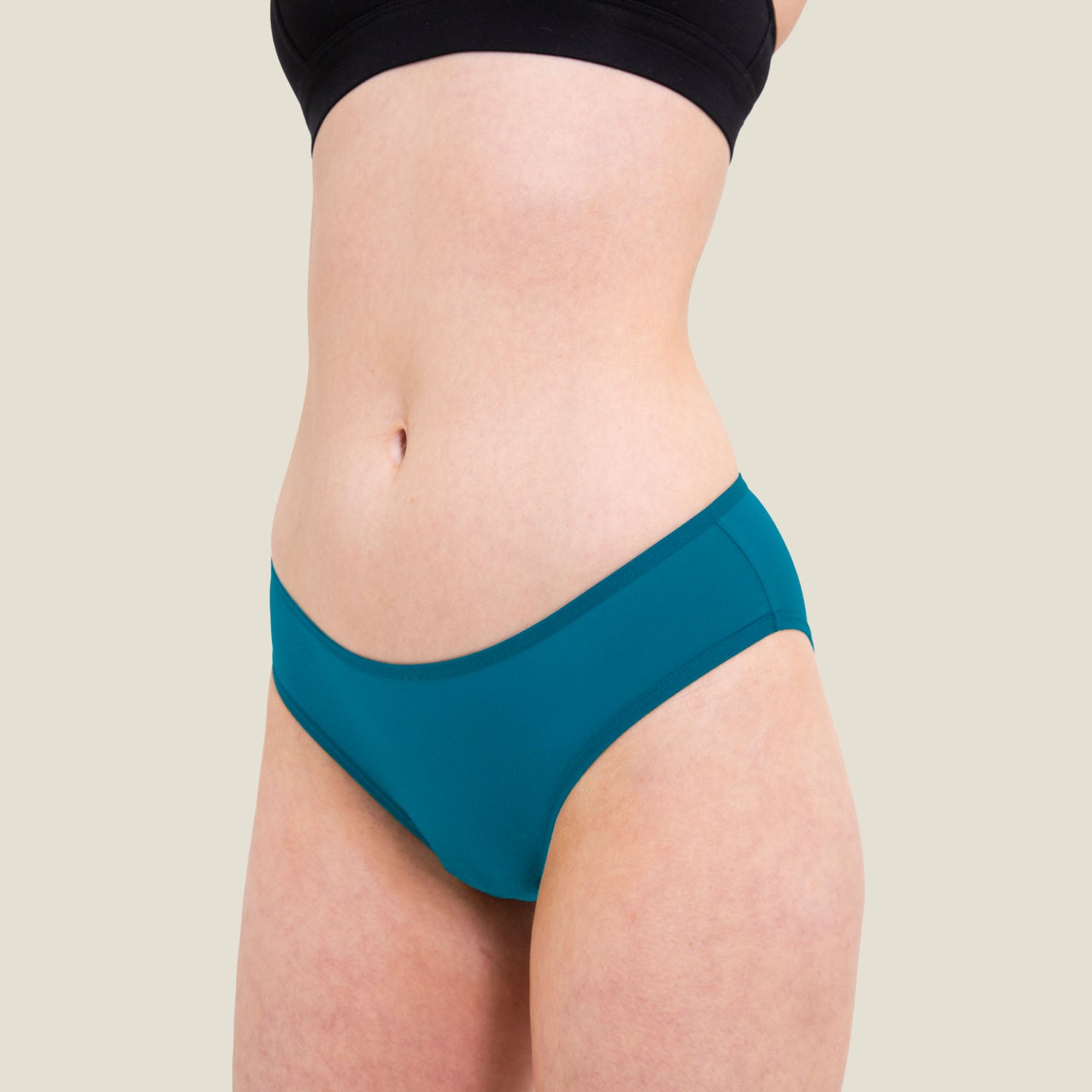 Side profile of WUKA blue bikini bottom for light flow, featuring sleek design and comfortable fit.