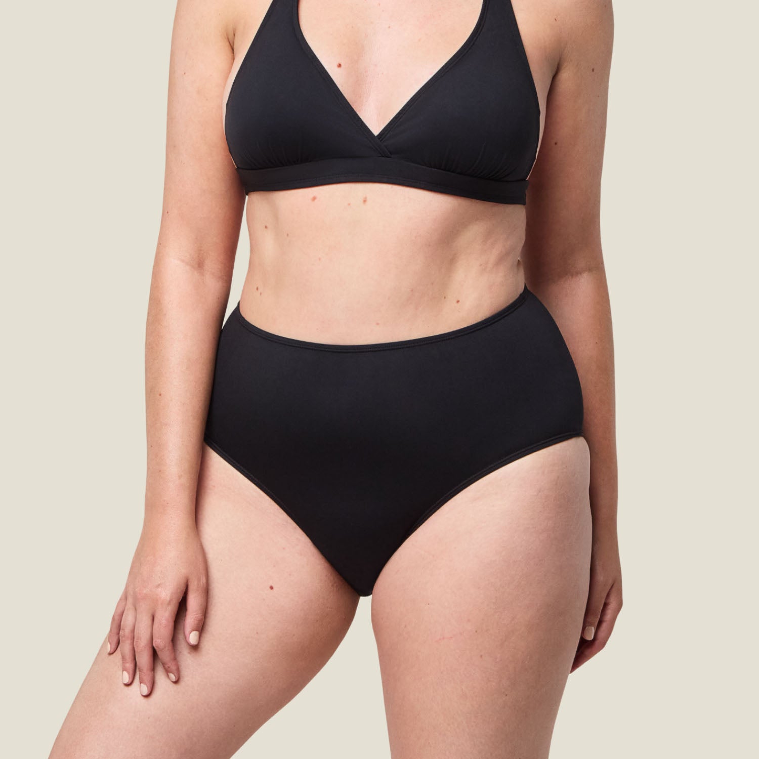 Side angle of WUKA Adult Swim High Waist bikini bottoms in black, showing sleek, comfortable design ideal for period swimming.