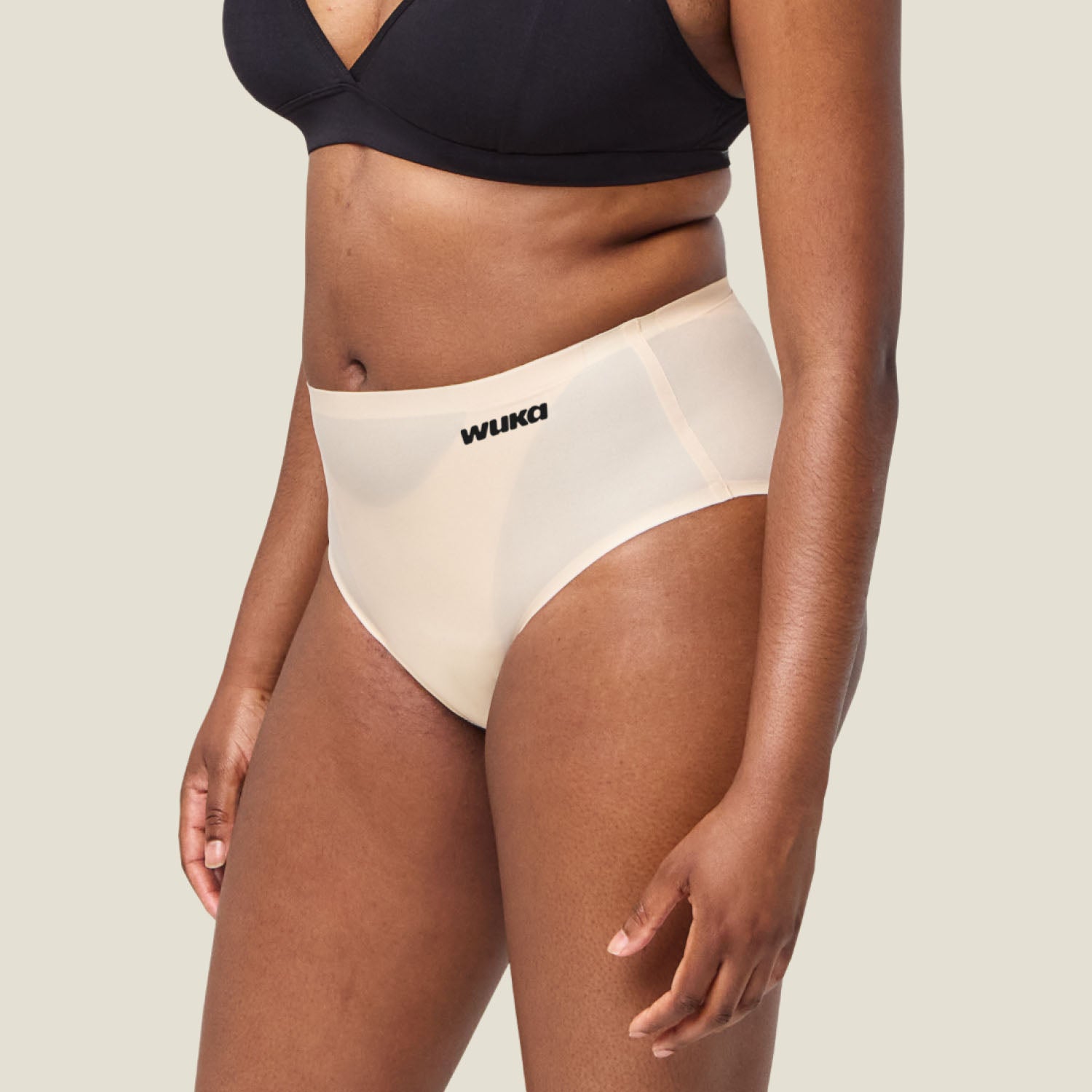 Side profile of WUKA Seamless Midi Brief in Light Nude for heavy periods, ultra-soft stretch fabric offering secure and discreet protection.