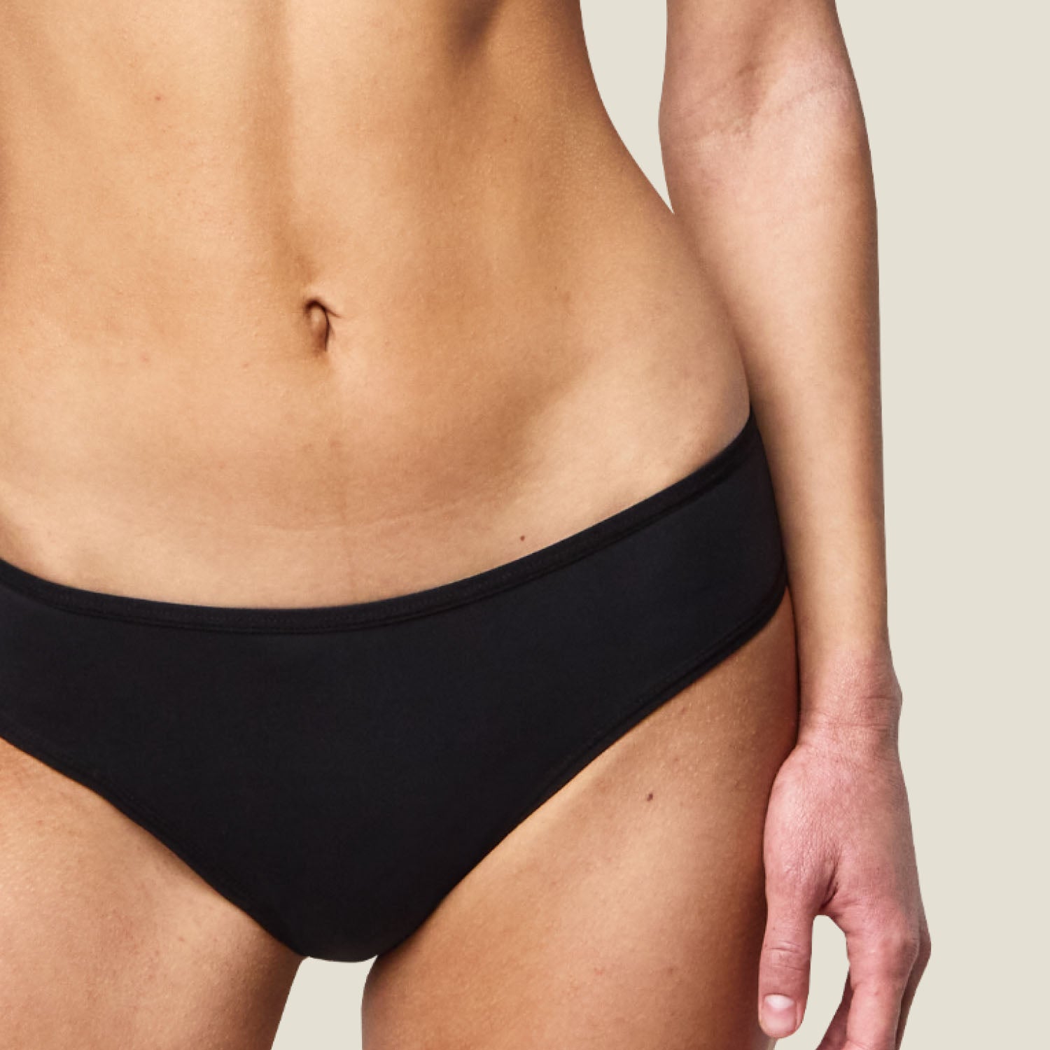 Close-up of WUKA Swim Bikini Brief material showing water-resistant, absorbent fabric engineered for light period flow and swimming comfort.