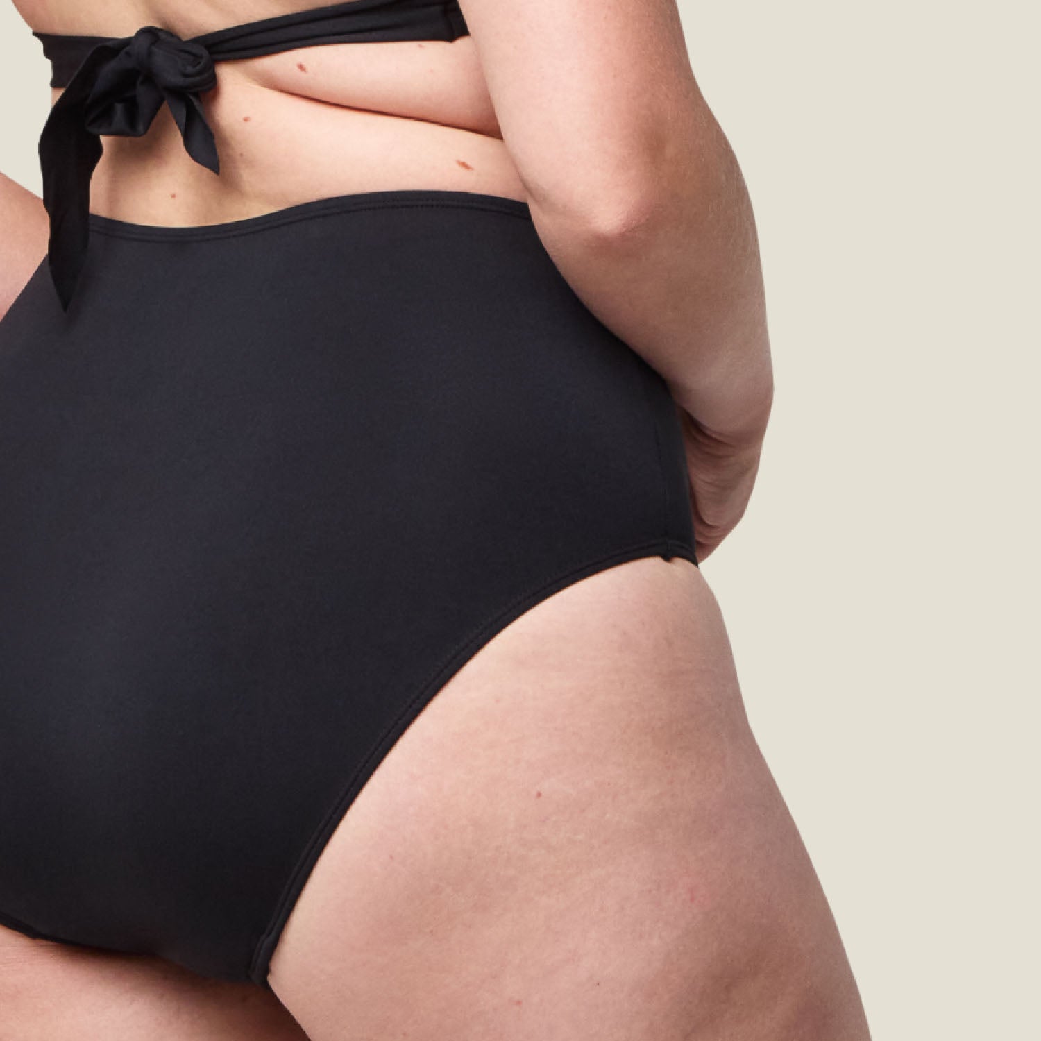 Zoomed-in detail of WUKA black swim period pants, showcasing high-quality material that offers light flow absorbency and water resistance.