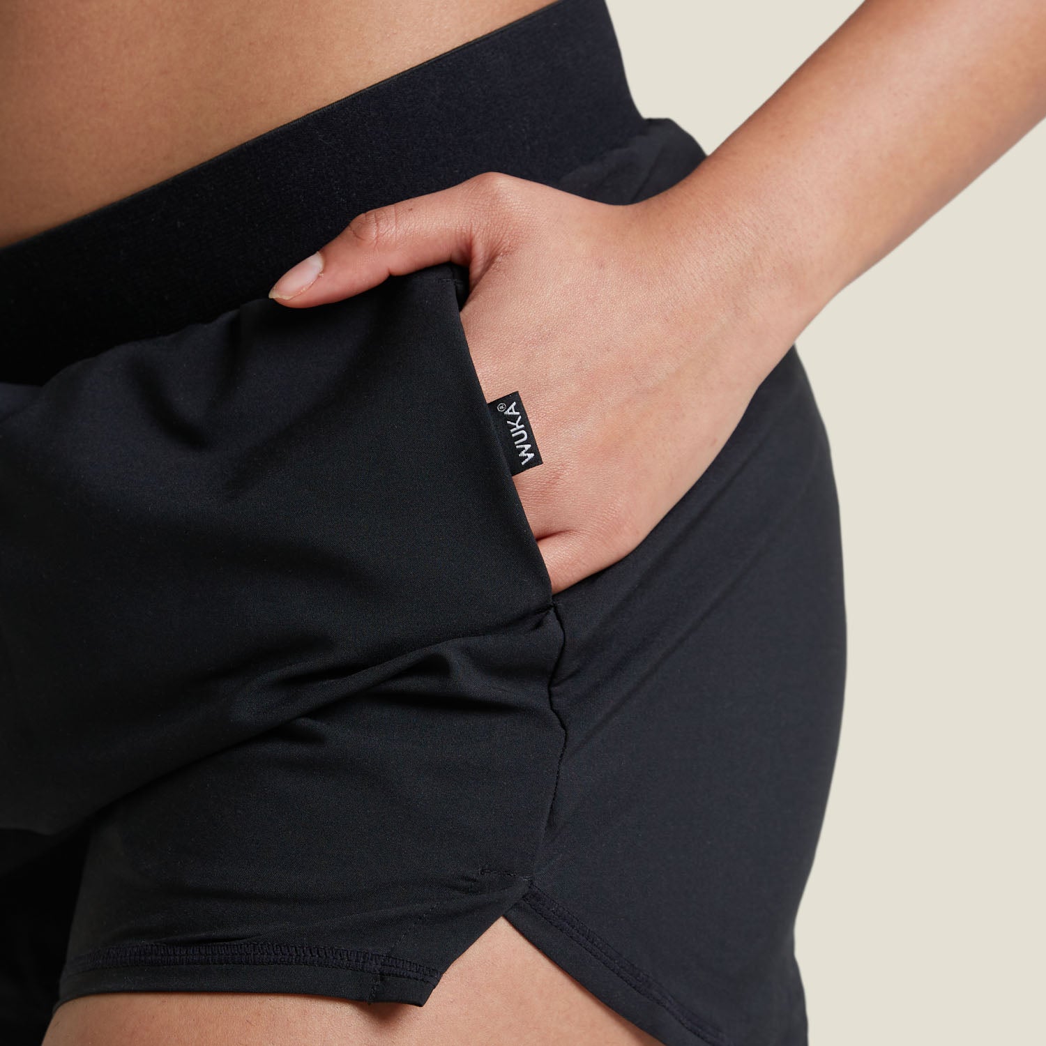 Detailed view of discreet side pocket on WUKA Period Sports Shorts, perfect for storing small essentials while staying active during your period.