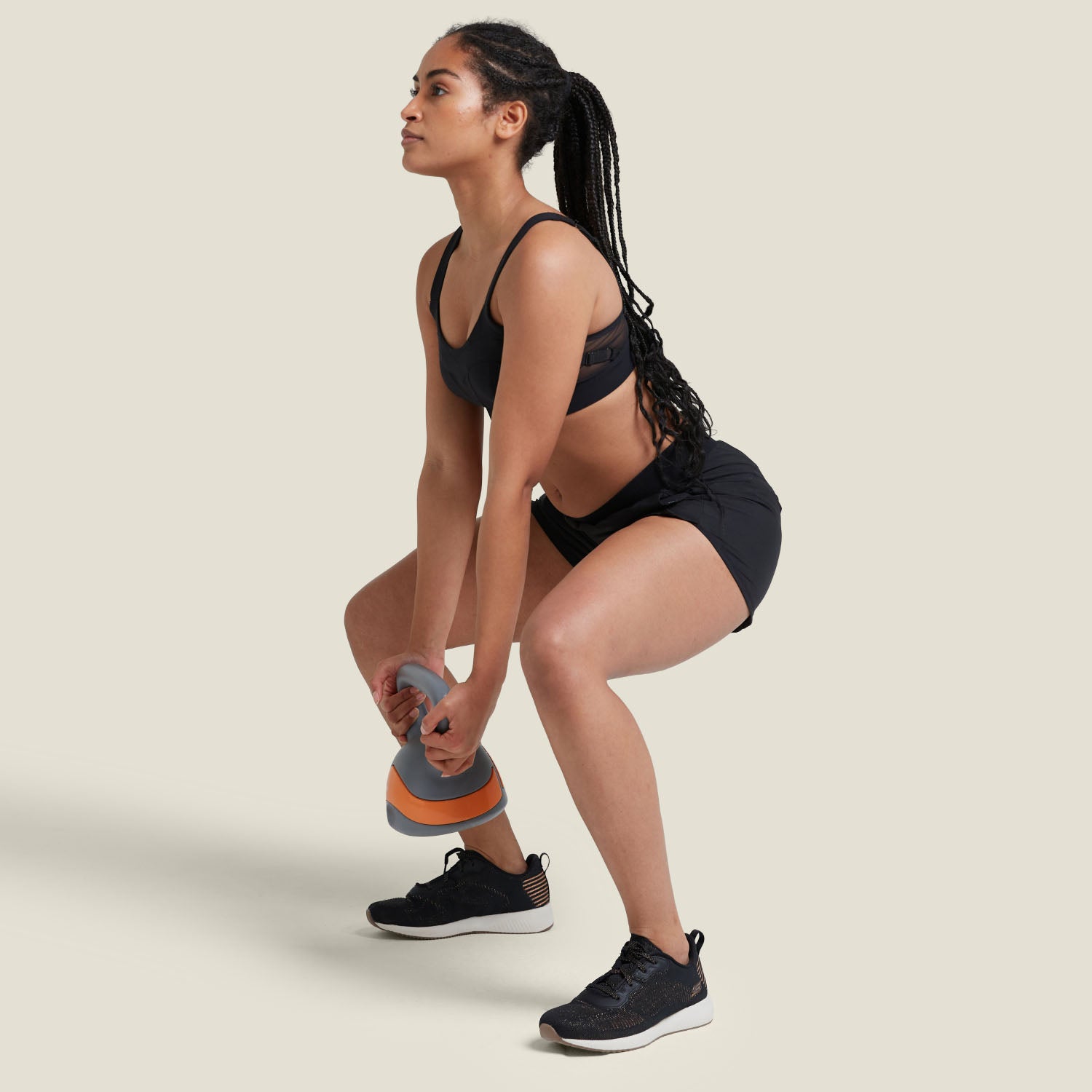 Model performing squat with kettlebell while wearing WUKA Period Sports Shorts, showcasing secure fit, movement support, and protection during workouts.