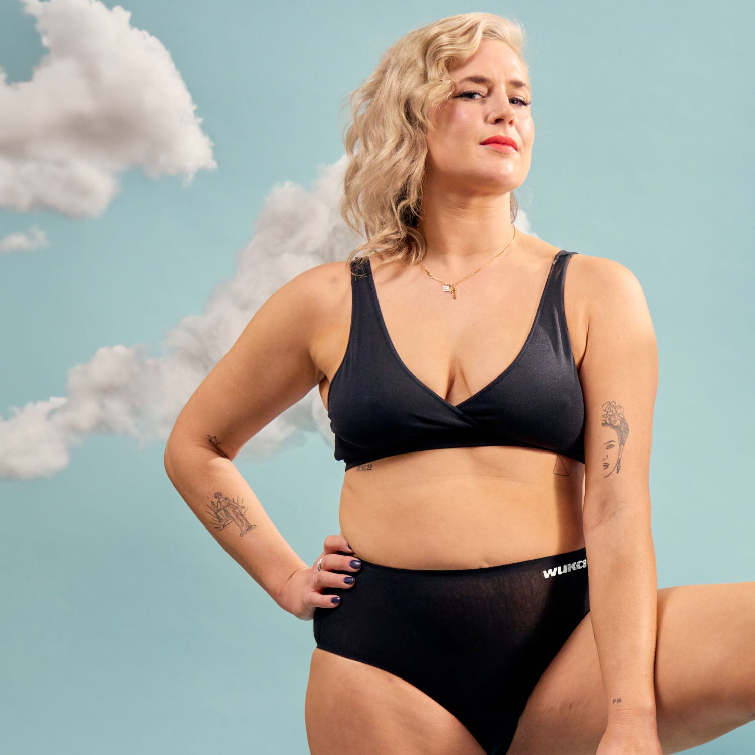 Confident model wearing WUKA Stretch Cotton Midi Brief heavy flow underwear in black, perfect for secure and comfortable period protection.